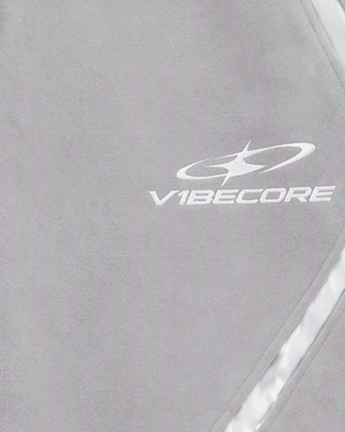 GREY ORBIT JOGGER — embroidered logo close-up